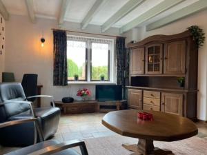 a living room with a table and a couch at Huisje Marie Loosdrecht in Loosdrecht