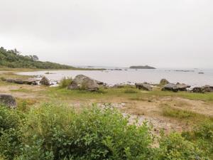 a beach with rocks and a body of water at Aisling in Foxford