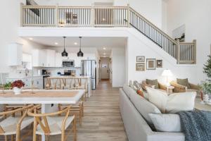 a living room and kitchen with a couch and a table at Panoramic Lake Views, Free Silver Dollar City Tickets, Stunning Decor in Kimberling City