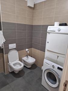 a bathroom with a toilet and a washing machine at PENTHAUS apartment in Banja Luka +43 photos