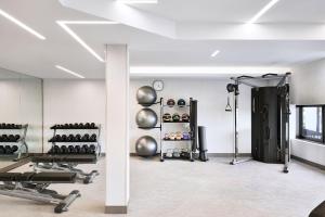 a room with a gym with dumbbells and weights at AC Hotel by Marriott San Diego Downtown Gaslamp Quarter in San Diego