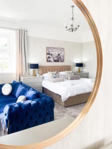a bedroom with two beds and a large mirror at Kenavara House in Oban