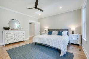 a white bedroom with a bed and a mirror at North Carolina Home about 2 Mi to Pinehurst Resort in Pinehurst