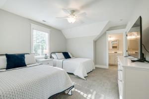 a bedroom with two beds and a flat screen tv at North Carolina Home about 2 Mi to Pinehurst Resort in Pinehurst