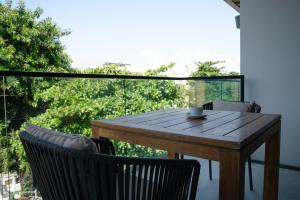a wooden table and chairs on a balcony at Fiesta Inn Playa del Carmen in Playa del Carmen +98 photos