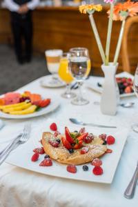 a plate of food with fruit on a table at Hotel Santander Plaza in Guatemala