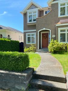 a house with a walkway leading to the front door at Hudson House in Vancouver