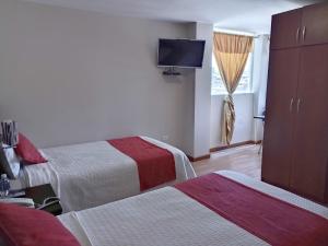 Postel nebo postele na pokoji v ubytování Hotel Versailles