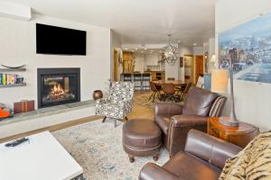 a living room with a couch and a fireplace at Torian Plum Creekside II in Steamboat Springs