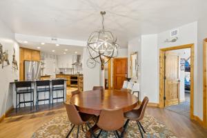 a kitchen and dining room with a wooden table and chairs at Torian Plum Creekside II in Steamboat Springs