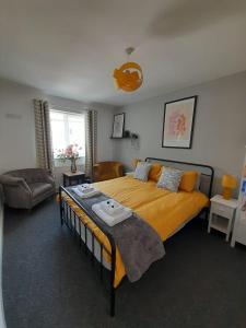 a bedroom with a large yellow bed and a couch at Church House in Gainsborough