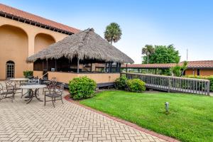 a pavilion with a table and chairs in a yard at Port of the Islands A101 in Naples