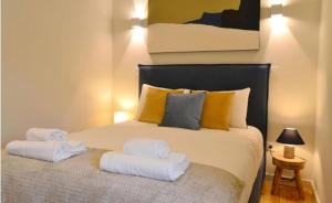 a bedroom with a bed with towels on it at Porto Pool Spot in Porto +22 photos