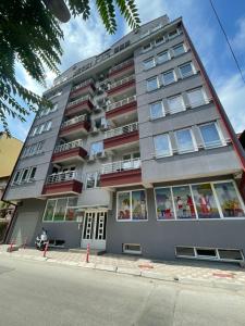 a tall gray building with lots of windows at Golden Apartment in Skopje