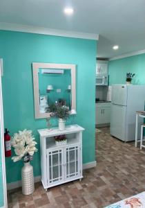 a kitchen with a blue wall and a white refrigerator at Beautiful and comfortable rom apt # 2 in Tampa