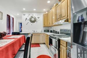 a kitchen with wooden cabinets and a stove top oven at Wilmington Home about 28 Mi to Downtown Philadelphia! in Wilmington