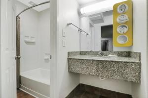 a bathroom with a sink and a shower at Motel 6-Bryan, TX - University Area in Bryan