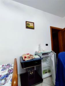 a room with a small refrigerator and a bed at Memory Tirana Apartments in Tirana