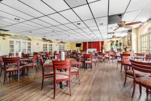 a dining room with wooden tables and chairs at Port of the Islands B111 in Naples