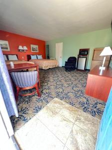 a hotel room with a bed and a desk at Town & Country Motel in Sioux City