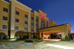 a hotel with a sign on the front of it at Hampton Inn & Suites Corsicana in Corsicana