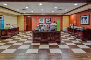 a large room with a checkerboard floor and counters at Hampton Inn & Suites Corsicana in Corsicana