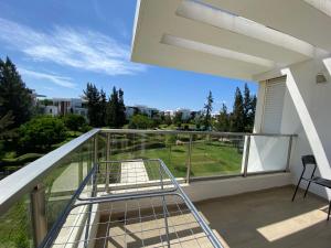 a balcony with a view of a yard at Prestigia Golf city Bouskoura Apartment in Bouskoura