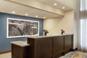 a waiting room with a motorcycle on the wall at Hampton Inn and Suites Springdale in Springdale