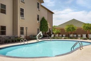 a large swimming pool in front of a building at Hampton Inn and Suites Springdale in Springdale