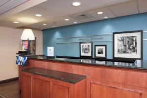 a waiting area of a waiting room with a counter at Hampton Inn & Suites Grand Rapids-Airport 28th St in Cascade