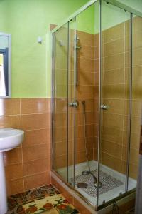 a shower with a glass door in a bathroom at L' Arco Antico in Caccamo