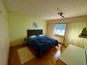 um quarto com uma cama com um cobertor azul em Miramar Mariehamn Åland em Mariehamn