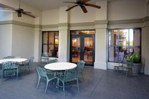 a patio with two tables and chairs and ceiling fans at Hampton Inn & Suites Greenville/Spartanburg I-85 in Duncan