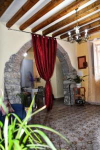 a red curtain in a room with a stone wall at L' Arco Antico in Caccamo