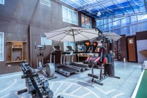 a gym with several tread machines and an umbrella at Life Hotel Valle Sagrado in Urubamba