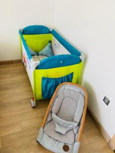 a childs bedroom with a crib and a baby seat at Prestigia Golf city Bouskoura Apartment in Bouskoura +28 photos