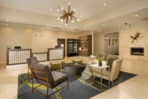 a living room with furniture and a fireplace at Homewood Suites by Hilton Midland in Midland