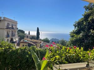 a view of the ocean from the balcony of a building at Taormina Family Apartment in Taormina