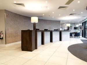 an office lobby with a reception desk and chairs at DoubleTree by Hilton Chester in Chester