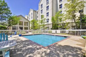 a swimming pool in front of a building at Hampton Inn & Suites Memphis East in Memphis