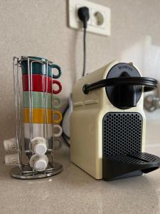 a toaster sitting on a kitchen counter next to cups at CASA ROSALÍA. APARTAMENTO CON VISTAS A LA MONTAÑA in Teror