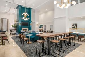 a dining room with a large table and chairs at Homewood Suites by Hilton New Orleans in New Orleans