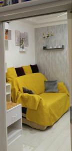 a bed with a yellow blanket in a room at Colorfull Experience in Hause built 1910 Fast free WiFi Free Parking in Rīga