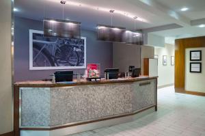 a lobby with a bar with a motorcycle on the wall at Hampton Inn Madison Square Garden in New York +15 photos