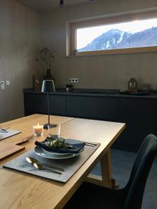 a table with a plate of food on top of it at KampenZeit Loft mit traumhaftem Panoramablick in Aschau im Chiemgau +69 photos