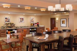 a dining room with wooden tables and chairs at DoubleTree by Hilton Portland Tigard in Tigard