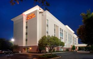 a hotel building with a sign on top of it at Hampton Inn & Suites Charlotte/Pineville in Charlotte