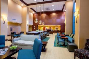 a lobby of a hospital with tables and chairs at Hampton Inn & Suites Sacramento-Elk Grove Laguna I-5 in Elk Grove