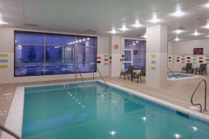 a large swimming pool in a hotel room at Homewood Suites by Hilton St. Louis - Galleria in Richmond Heights