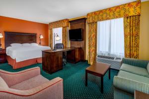 a hotel room with a bed and a desk and chairs at Hampton Inn & Suites Sacramento-Elk Grove Laguna I-5 in Elk Grove